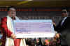 Chief Minister of Meghalaya, Dr. Mukul Sangma handing over a Cheque of Rs.5 lakhs to Neil Nongkynrih of Shillong Chamber Choir
