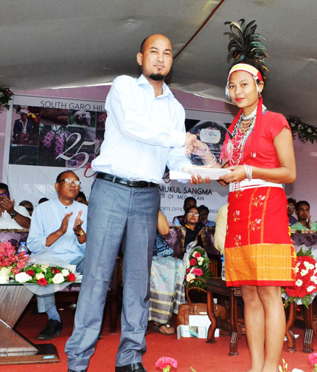 Click to enlarge Parliamentary Secretary, C&RD & IPR R S Marak felicitates an outstanding student of the SSLC examination